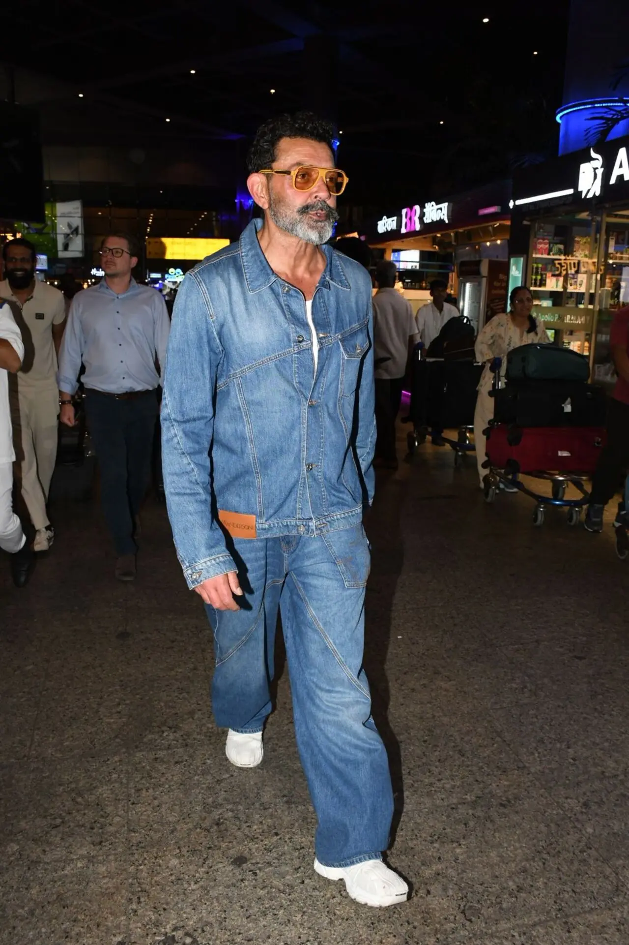 Bobby Deol was spotted in a cool denim-on-denim look as he was clicked at the airport. Pairing the casual outfit with white sneakers and tinted sunglasses. Bobby Deol was spotted in a cool denim-on-denim look as he was clicked at the airport. Pairing the casual outfit with white sneakers and tinted sunglasses.